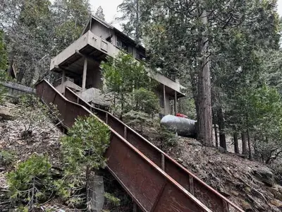 a building on the side of a hill with trees at Views inside Yosemite-Timber Lodge-Sleeps 6 in Yosemite West