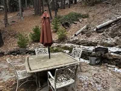 an umbrella sitting on a table with two chairs at Views inside Yosemite-Timber Lodge-Sleeps 6 in Yosemite West