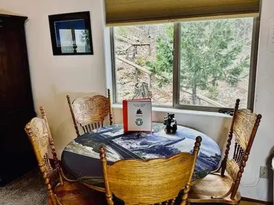a dining room with a table and a window at Yosemite Woods Duplex in Yosemite-Upper Unit in Yosemite West