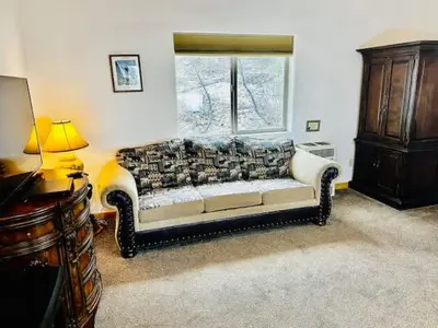 a living room with a couch and a window at Yosemite Woods Duplex in Yosemite-Upper Unit in Yosemite West