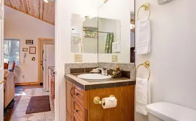 a bathroom with a sink and a mirror at Yosemite Woods Duplex in Yosemite-Upper Unit in Yosemite West