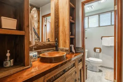 a bathroom with a wooden sink and a toilet at Canyon Slopeside Retreat in Mammoth Lakes