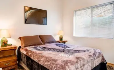 a bedroom with a large bed and a window at Lower Unit-Yosemite Woods-Inside Yosemite in Yosemite West