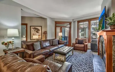 a living room with a leather couch and chairs at Palisades Village ski in ski out Mountain Retreat in Olympic Valley
