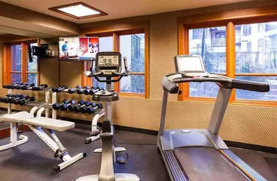 a gym with two tread machines and a treadmill at Palisades Village ski in ski out Mountain Retreat in Olympic Valley