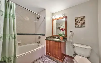 a bathroom with a tub and a toilet and a sink at Palisades Village ski in ski out Mountain Retreat in Olympic Valley