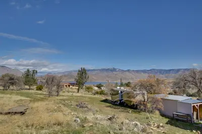 a train sitting in a field with mountains in the background at 6 Mi to Lake Isabella Mountain Mesa Getaway in Mountain Mesa