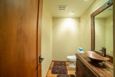 a bathroom with a wooden sink and a toilet at Plush Mammoth Condo w Balcony Views in Mammoth Lakes