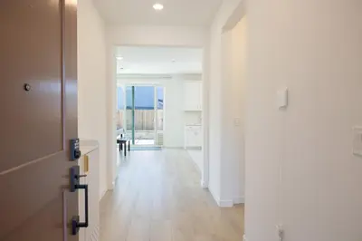an empty hallway with white walls and wooden floors at Modern Charming 4BR Home, Family Friendly, Office Space, Fast WiFi, Free Parking in Folsom
