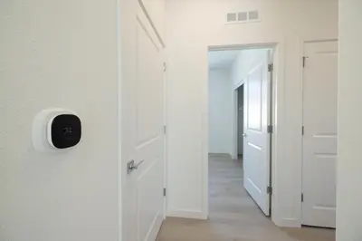 a hallway with white walls and an open door at Modern Charming 4BR Home, Family Friendly, Office Space, Fast WiFi, Free Parking in Folsom