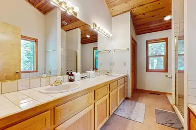 a bathroom with two sinks and a large mirror at Evergreen Escape in Truckee