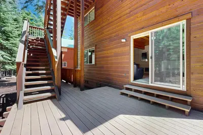 a wooden deck with a staircase next to a house at Evergreen Escape in Truckee