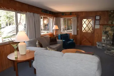 a living room with a couch and a table at Sequoia House at The Redwoods in Wawona
