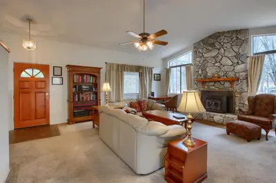 a living room with a couch and a fireplace at Cabin Among the Firs in Wawona