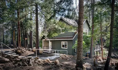 a small house in the middle of a forest at Margaret's at The Redwoods in Wawona