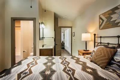 a bedroom with a bed and a bathroom at Spring Meadow Retreat in Wawona