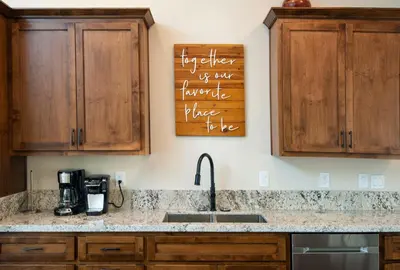 a kitchen with wooden cabinets and a sink at Spring Meadow Retreat in Wawona