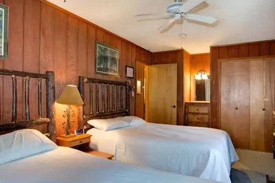 a bedroom with two beds and a ceiling fan at Star Gazers in Wawona