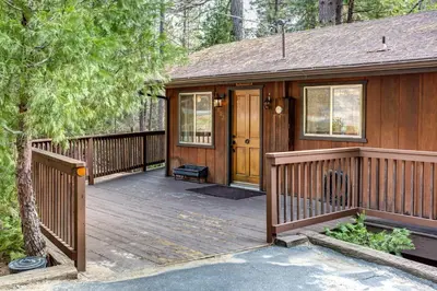 a home with a wooden deck with a house at Star Gazers in Wawona