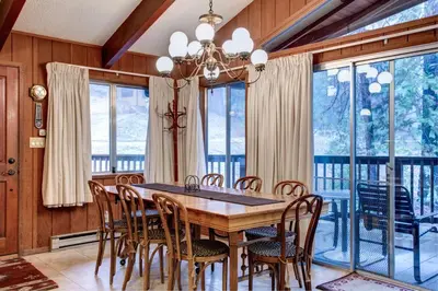 a dining room with a wooden table and chairs at Star Gazers in Wawona