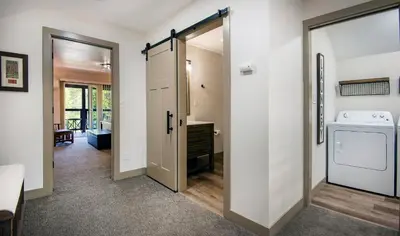 a laundry room with a door and a washer and dryer at Hilltop Haven in Wawona