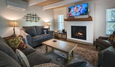 a living room with a couch and a fireplace at Hilltop Haven in Wawona