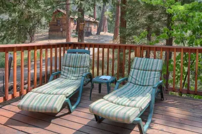 two chairs and a table on a deck at Chipmunks Holiday in Wawona