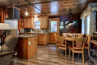 a kitchen and dining room with a table and chairs at Chipmunks Holiday in Wawona