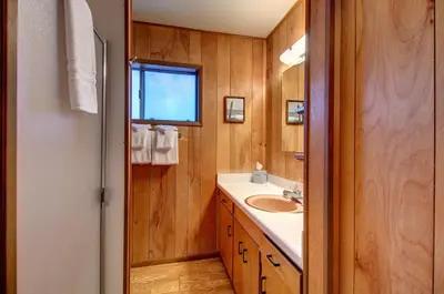 a bathroom with a sink and a mirror at Longview at The Redwoods in Wawona