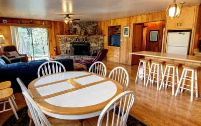 a living room with a table and chairs at Longview at The Redwoods in Wawona