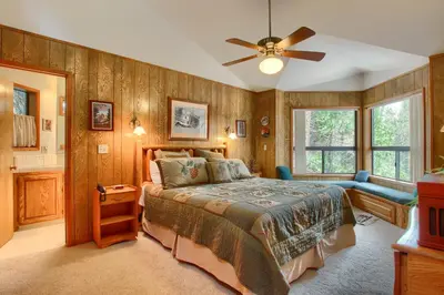 a bedroom with a bed and a ceiling fan at Pohono Pines in Wawona