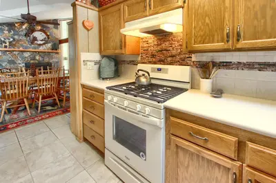 a kitchen with a white stove top oven in a kitchen at Pohono Pines in Wawona