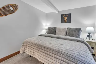 a bedroom with a large bed in a room at Big Foots Den on the 10 Northstar Resort Truckee in Truckee