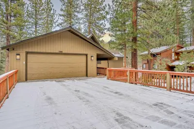 a garage in front of a house with a fence at Big Foots Den on the 10 Northstar Resort Truckee in Truckee
