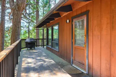 a porch of a house with an open door at Hiltbrand Hangout in Wawona