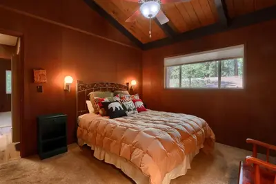 a bedroom with a bed and a ceiling fan at Hiltbrand Hangout in Wawona