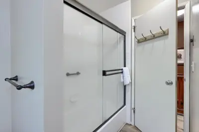 a shower with a glass door in a bathroom at Hiltbrand Hangout in Wawona