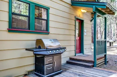a house with a grill on the front porch at Wawona Retreat in Wawona