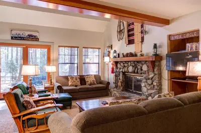 a living room with a couch and a fireplace at Wawona Retreat in Wawona