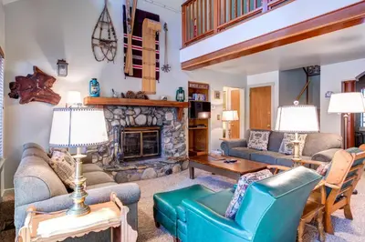 a living room with couches and a fireplace at Wawona Retreat in Wawona