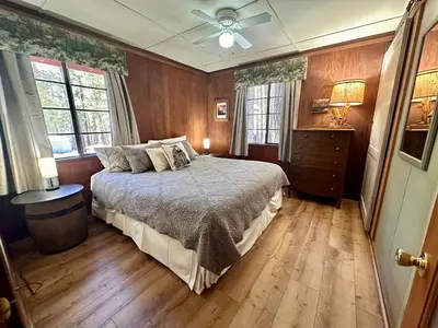 a bedroom with a bed and a ceiling fan at Heart of the Meadow in Wawona