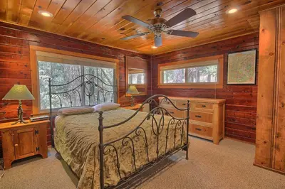 a bedroom with a bed and a ceiling fan at The Tree House in Wawona