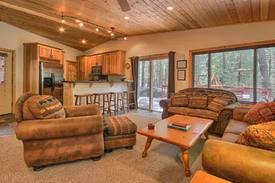 a living room with two couches and a table at The Tree House in Wawona