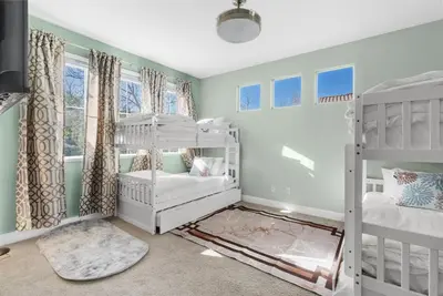 a bedroom with two bunk beds and a window at Game Lovers Retreat, spacious 4000 sqft Getaway in El Dorado Hills