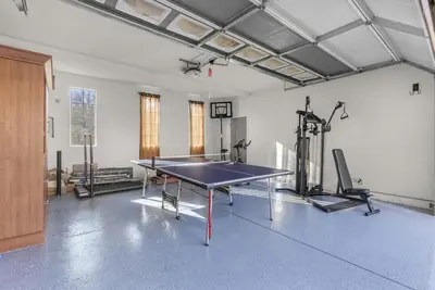 a gym with a ping pong table and exercise bikes at Game Lovers Retreat, spacious 4000 sqft Getaway in El Dorado Hills