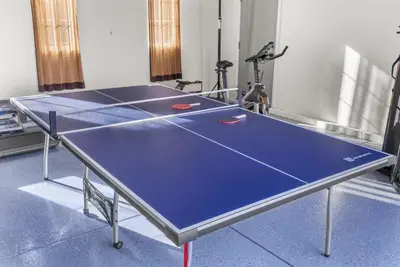 a ping pong table in a room with a ping pong ball at Game Lovers Retreat, spacious 4000 sqft Getaway in El Dorado Hills