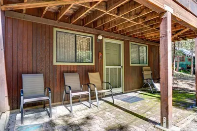 a screened porch with chairs and a house at Cecil's Cabin in Wawona