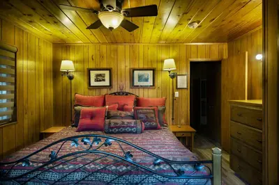 a bedroom with a bed with a ceiling fan at We-Dunn-It in Wawona