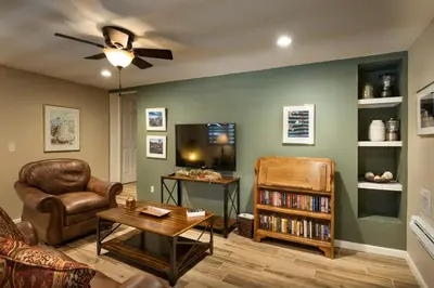 a living room with a couch chair and a tv at We-Dunn-It in Wawona