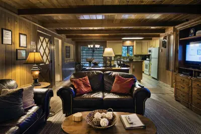 a living room with a leather couch and a television at We-Dunn-It in Wawona